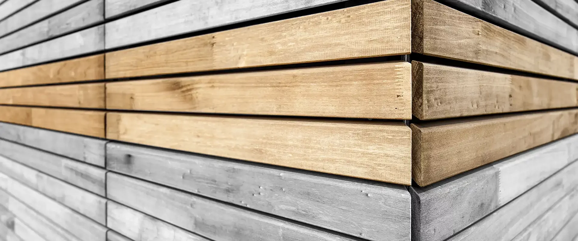 Corner view of a timber facade with horizontal slats.