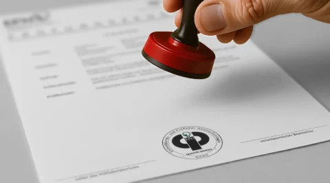 Hand stamping a document with the EPH quality mark.